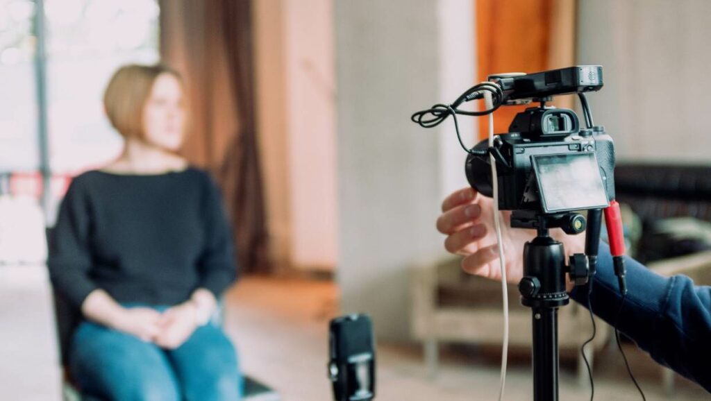 A professional setting with a camera crew capturing an interview for video content creation