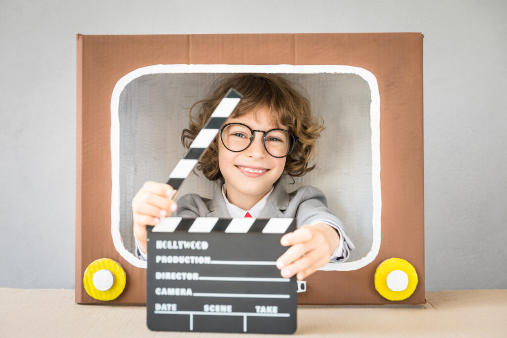 Kid looking out of a TV box in a TV Commercial