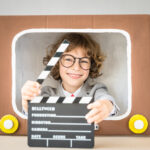 Kid looking out of a TV box in a TV Commercial