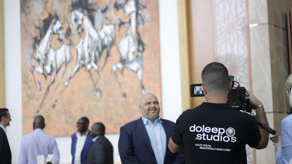 A video production crew member filming an interview for a corporate event production