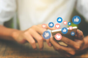 Young man using a smartphone for social media video ads engagement