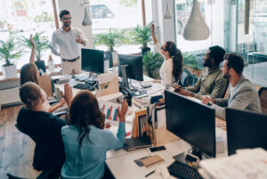 Employees engaged in a discussion about the benefits of employee onboarding videos in a modern workplace.
