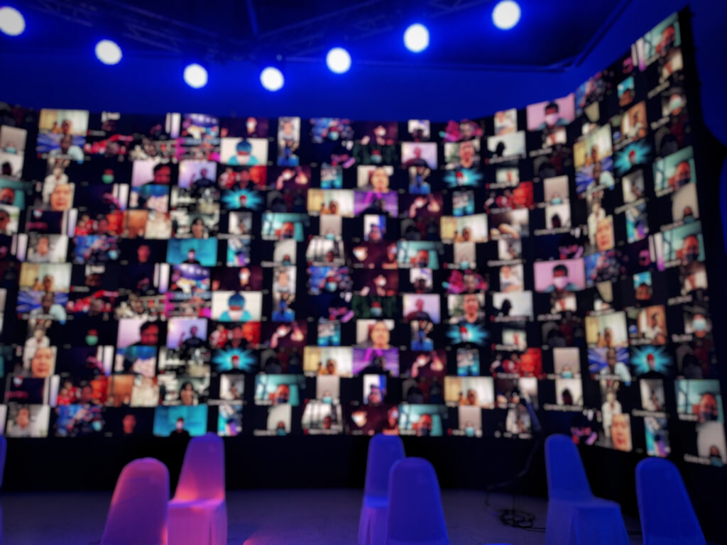An image of a webinar displayed on a screen, representing the impact of webinar production in engaging the UAE audience.