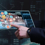 Close-up of a laptop screen displaying a marketing video with focus keyword "Marketing Videos