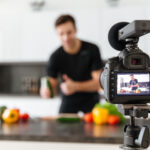 Video camera capturing a person explaining for an explainer video in Your Explainer Videos Guide