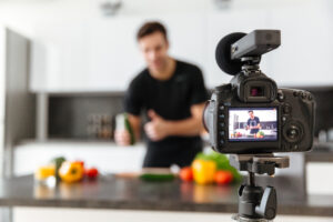 Video camera capturing a person explaining for an explainer video in Your Explainer Videos Guide