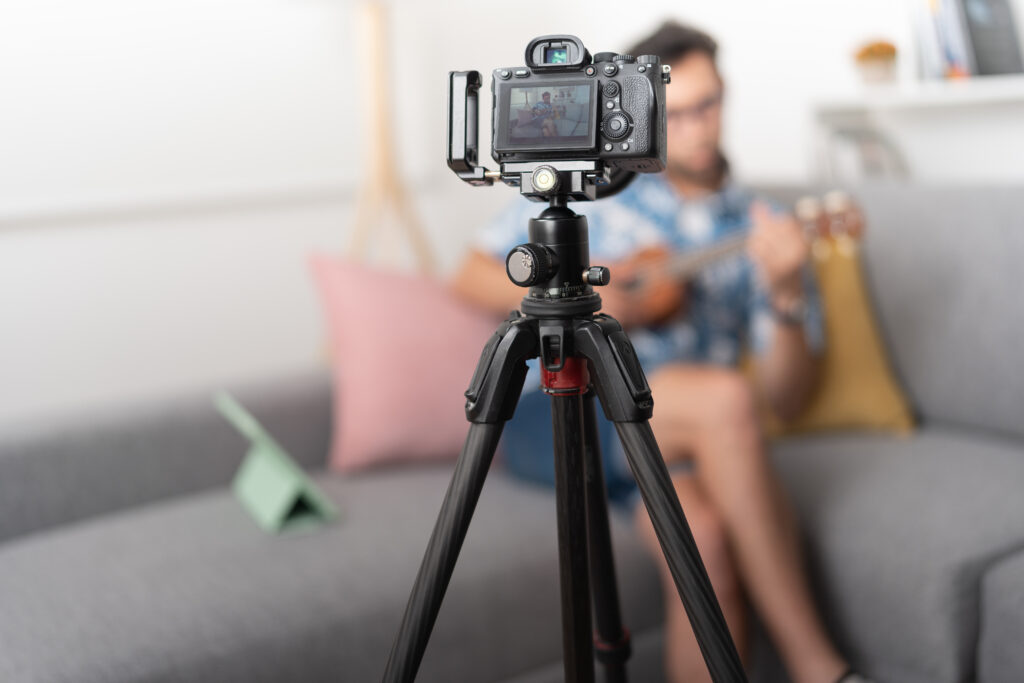 Camera mounted on a tripod, symbolizing the creation of short feature videos